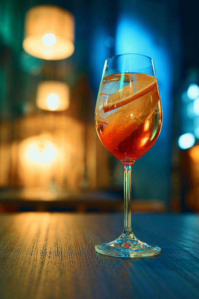 Colorful cocktail in glass with orange and lemon